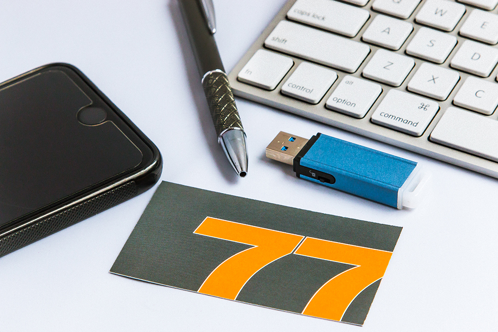 Who is Your Customer? 77 Design Co business card, keyboard, and flash drive.