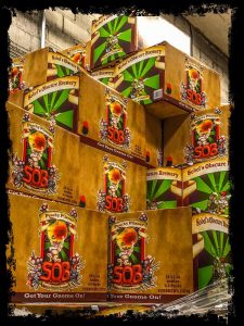 Interview-Sobel's Obscure Brewery. Image of cases of Peachy Pilsner stacked upon one another with a black border.