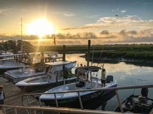 A Week Away. Photograph of boats docked at sunrise in the marina.