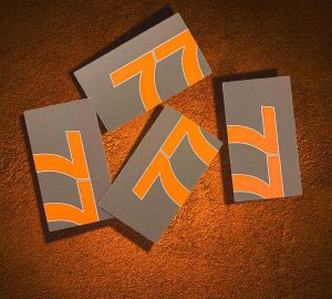 Give us your marketing problems. An image of the 77 Design Co orange and grey logo with a textured background.