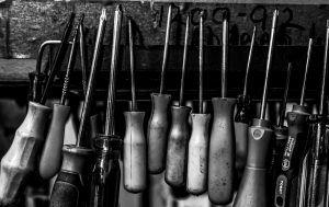 Give Us Your Marketing Problems. An image of black & white tools. 