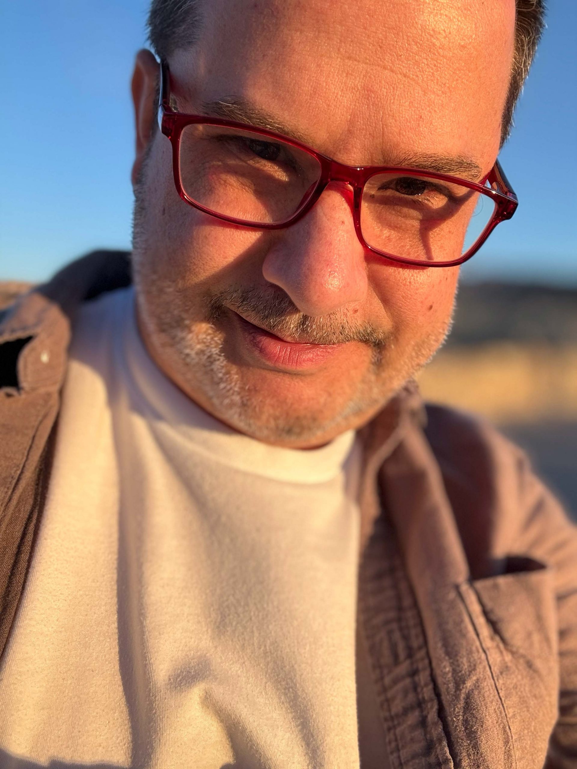 A picture of the company founder wearing red glasses